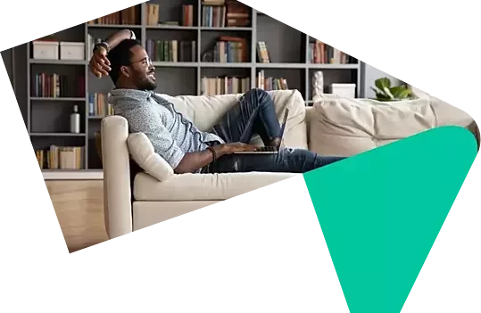 Man relaxing at home on the sofa applying to use Your Home